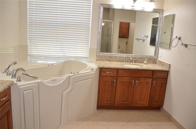 bathroom featuring vanity, a tub, and tile patterned flooring