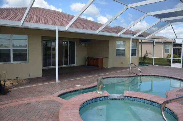 view of swimming pool featuring a lanai, a patio, and an in ground hot tub