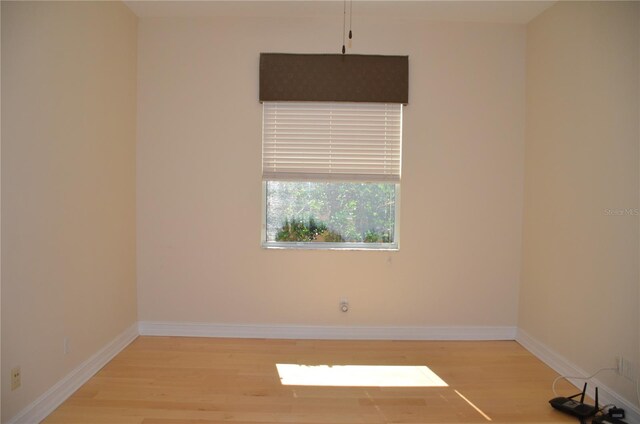 unfurnished room with wood-type flooring