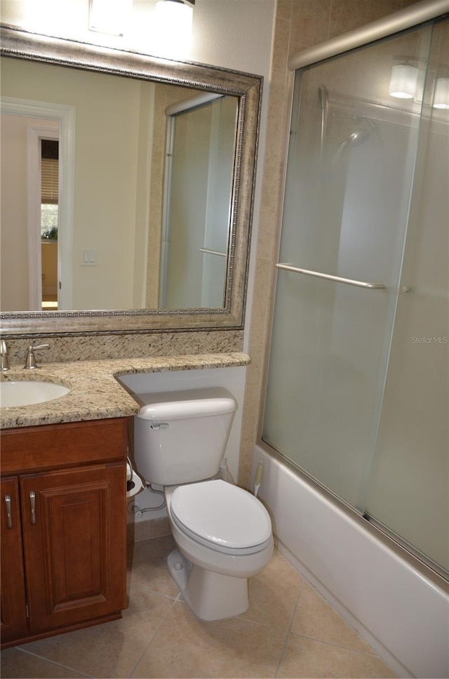 full bathroom with tile patterned flooring, shower / bath combination with glass door, vanity, and toilet