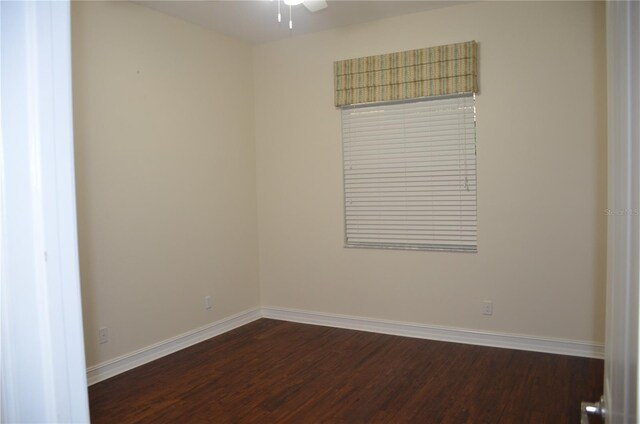 spare room with ceiling fan and dark hardwood / wood-style floors