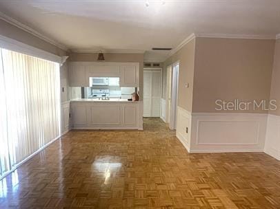 interior space with ornamental molding and parquet floors