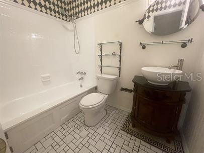 full bathroom featuring toilet, tile patterned flooring, vanity, and tub / shower combination