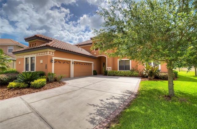 view of front of house with a front yard and a garage