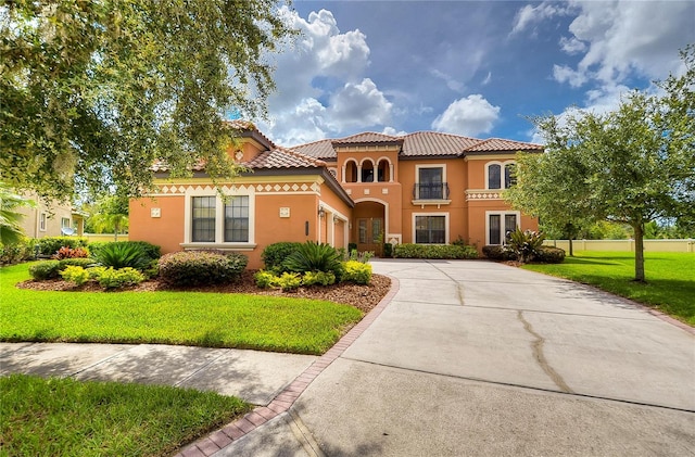 mediterranean / spanish-style house with a front lawn