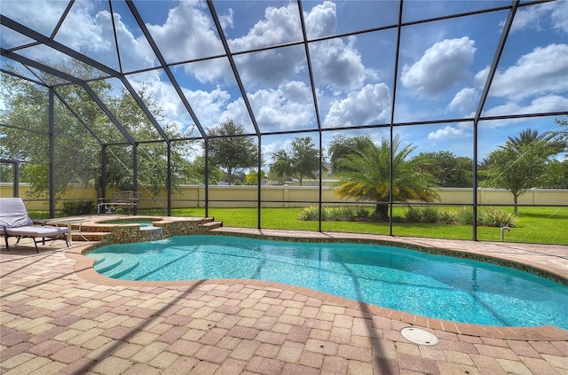 view of pool featuring a yard, glass enclosure, an in ground hot tub, and a patio area