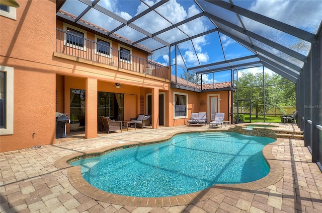 view of swimming pool with a patio area, an in ground hot tub, outdoor lounge area, and grilling area