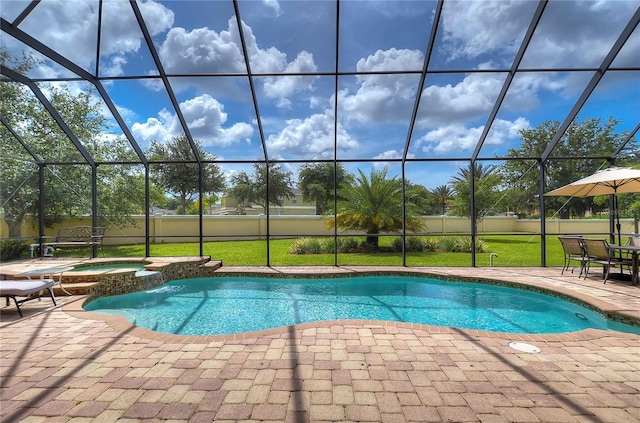 view of swimming pool with an in ground hot tub, a yard, glass enclosure, and a patio area