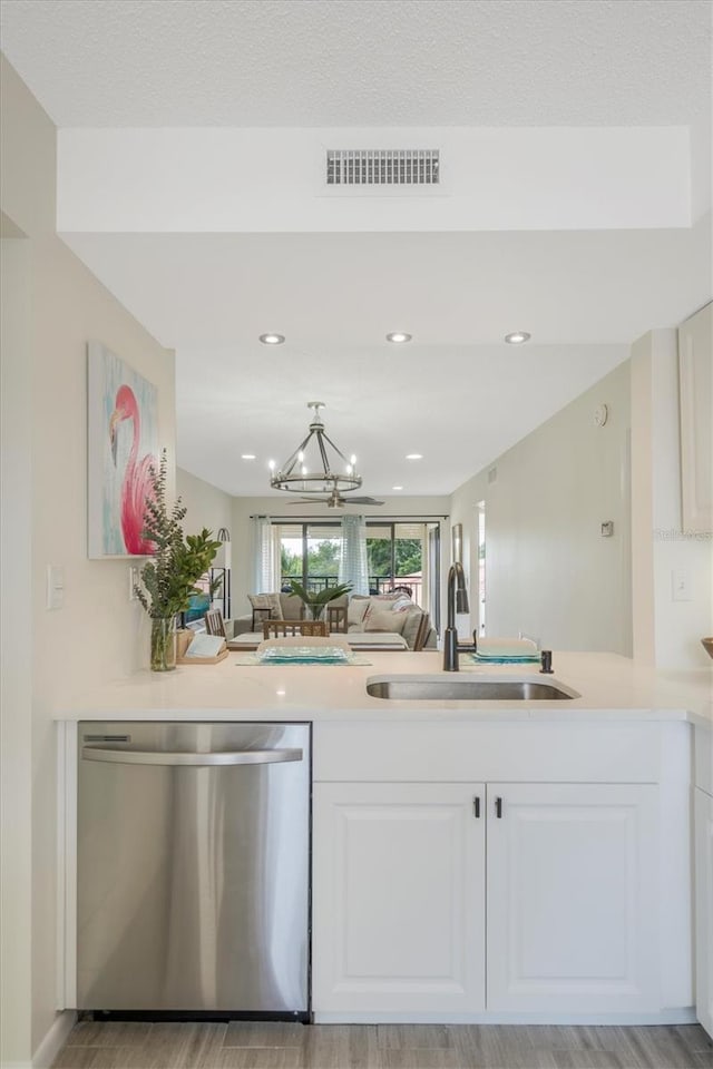 kitchen featuring dishwasher, white cabinetry, light hardwood / wood-style flooring, and sink