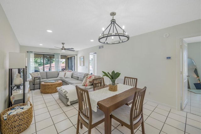 dining space featuring light tile patterned floors and ceiling fan with notable chandelier