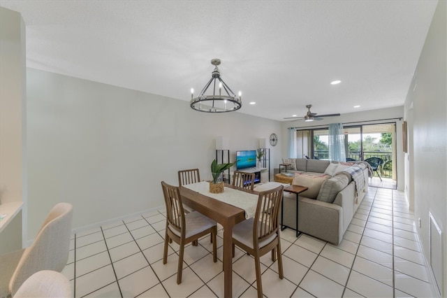 dining space featuring light tile patterned floors and ceiling fan with notable chandelier