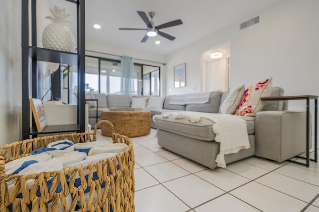 tiled living room with ceiling fan