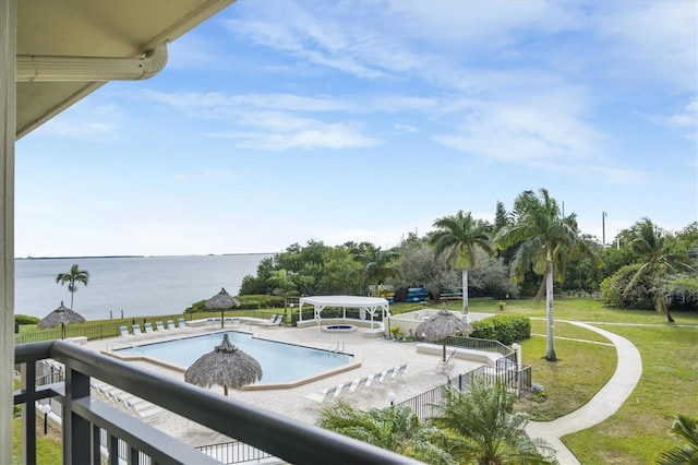 view of swimming pool with a gazebo, a water view, a yard, and a patio