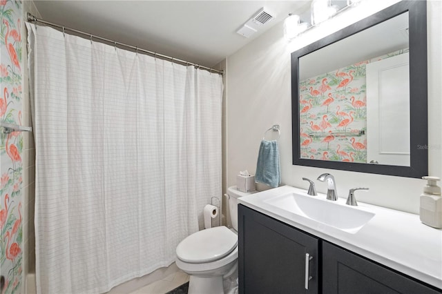 bathroom featuring tile patterned flooring, vanity, and toilet