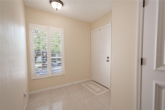 doorway with a textured ceiling