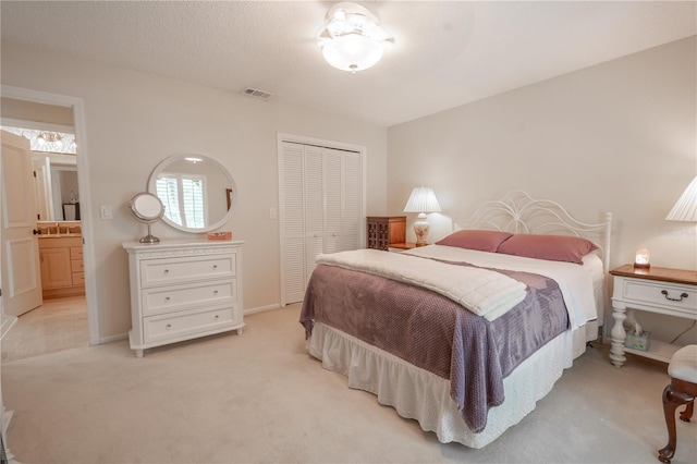 carpeted bedroom with connected bathroom and a closet