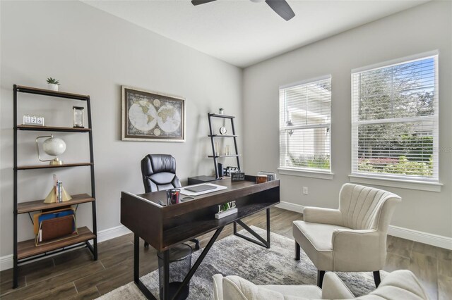 office area with dark wood-style flooring and baseboards