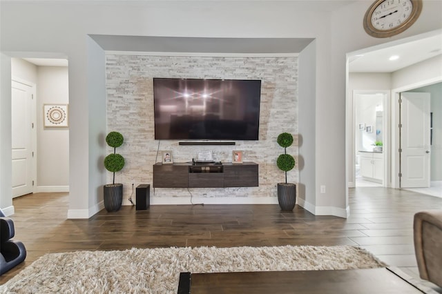 living room featuring wood finished floors and baseboards