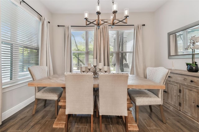 dining room featuring dark wood-style floors, a chandelier, and baseboards