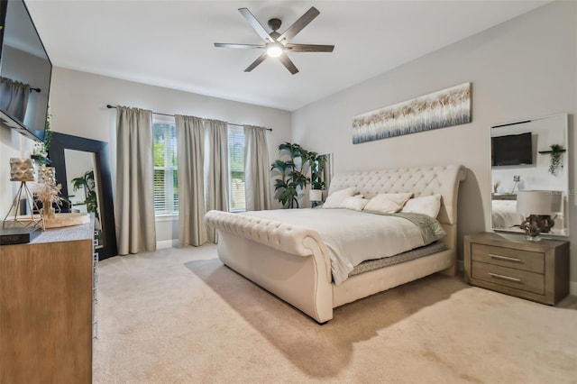 bedroom with ceiling fan and light colored carpet