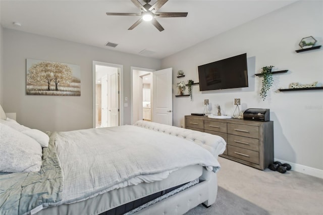 bedroom featuring light colored carpet, ceiling fan, visible vents, and baseboards