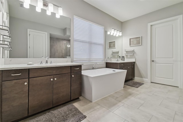 101 Brookover Ln, Brandon, FL 33511 - bathroom featuring a freestanding bath, two vanities, a sink, and visible vents
