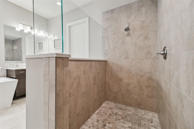 bathroom featuring a freestanding tub, walk in shower, and vanity