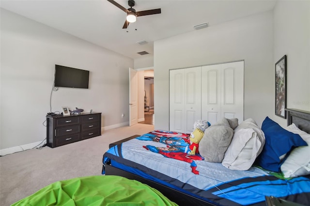 bedroom featuring light carpet, baseboards, visible vents, and a closet