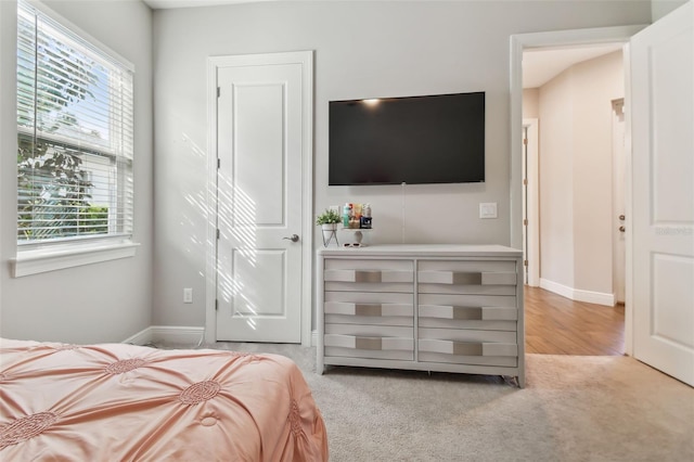 bedroom with carpet floors and baseboards