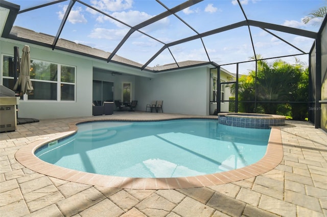 view of pool with a pool with connected hot tub, a lanai, and a patio