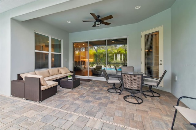 view of patio / terrace featuring outdoor dining space, ceiling fan, and an outdoor hangout area