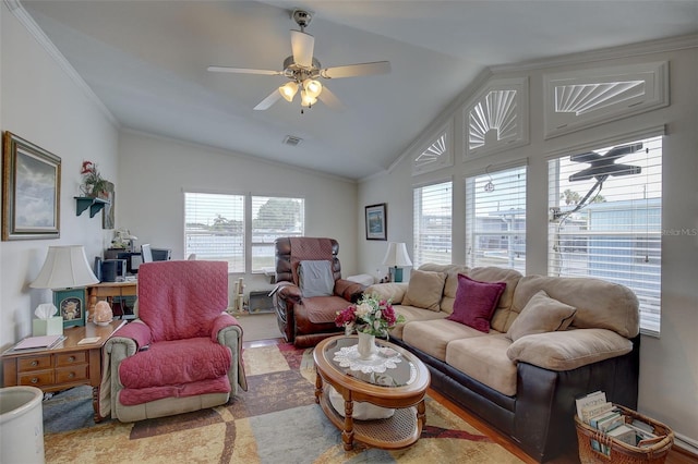 living room featuring ceiling fan, ornamental molding, lofted ceiling, and plenty of natural light