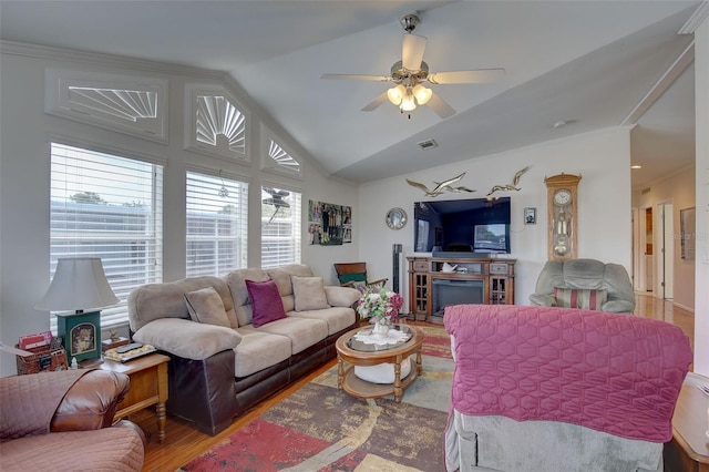 living room with hardwood / wood-style floors, vaulted ceiling, and ceiling fan