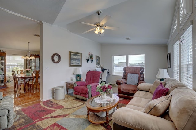 living room featuring lofted ceiling, crown molding, ceiling fan with notable chandelier, and light tile patterned floors