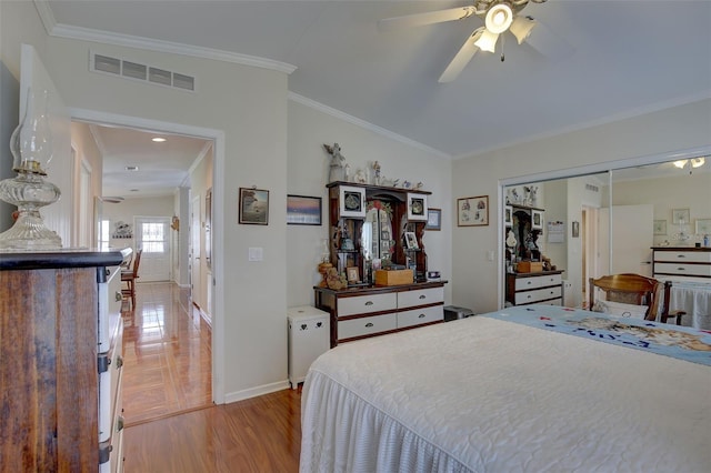 bedroom with a closet, ceiling fan, and ornamental molding