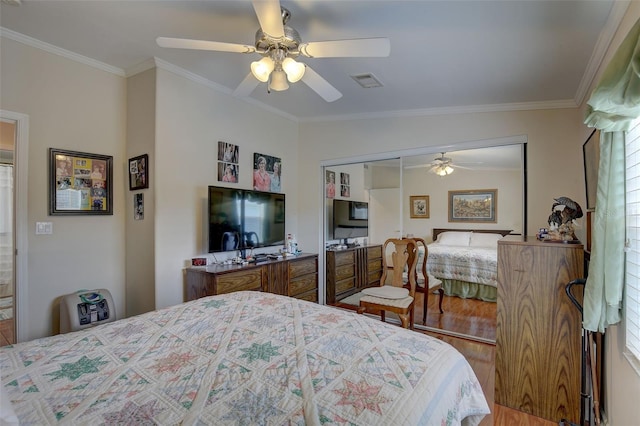 bedroom with crown molding, wood-type flooring, a closet, and ceiling fan