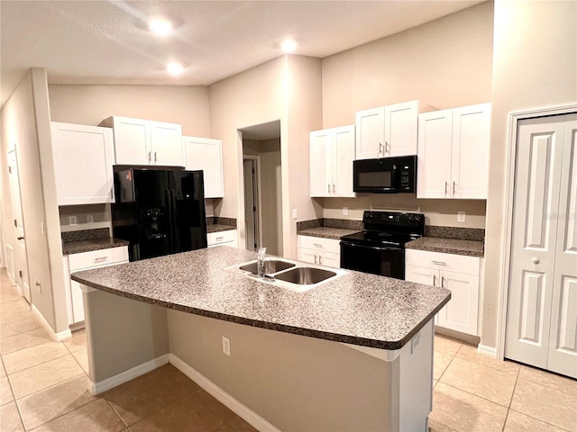 kitchen with sink, an island with sink, lofted ceiling, white cabinets, and black appliances