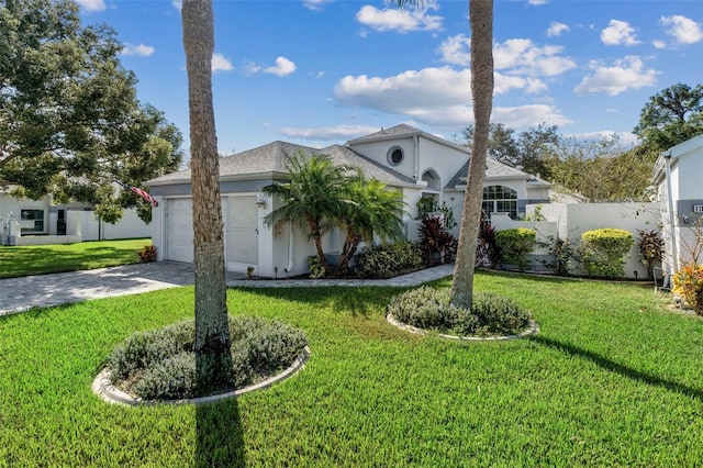 view of front facade with a front yard and a garage