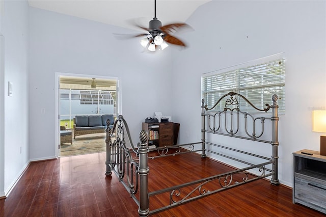 bedroom featuring ceiling fan, hardwood / wood-style flooring, and high vaulted ceiling