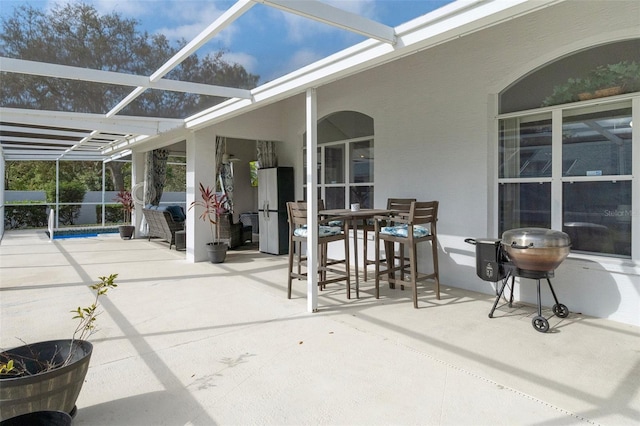 view of patio featuring a lanai