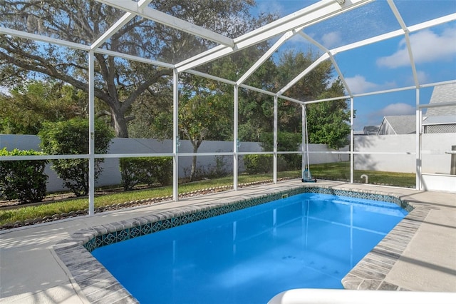 view of pool featuring a patio area and glass enclosure