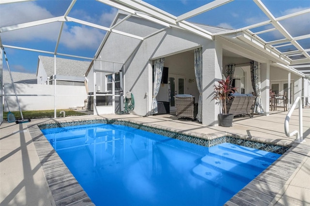 view of pool with a patio, french doors, and a lanai