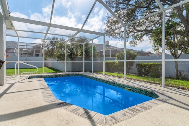 view of pool with a patio and glass enclosure