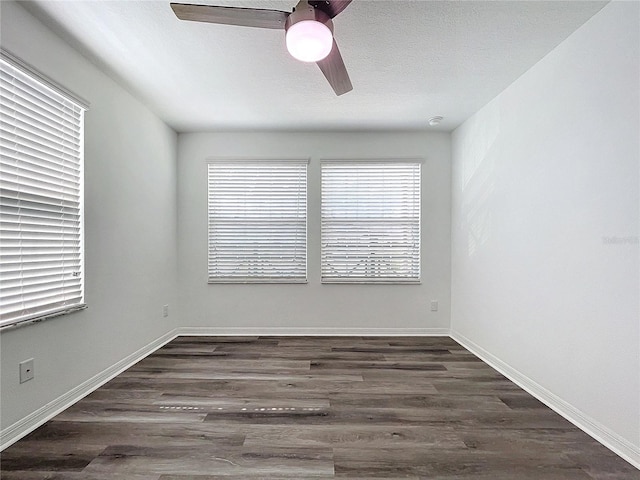 empty room with ceiling fan, a textured ceiling, and dark hardwood / wood-style flooring