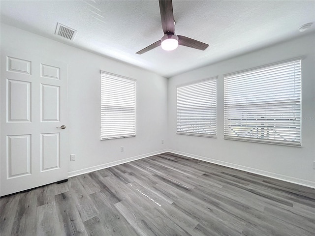 unfurnished room with light hardwood / wood-style floors, a textured ceiling, plenty of natural light, and ceiling fan