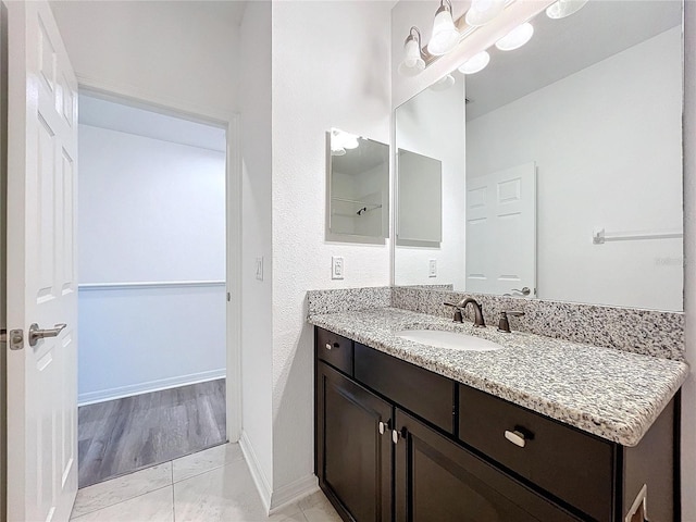 bathroom with vanity and wood-type flooring