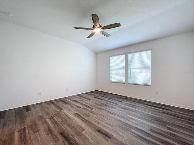 unfurnished room with ceiling fan, lofted ceiling, and dark hardwood / wood-style flooring