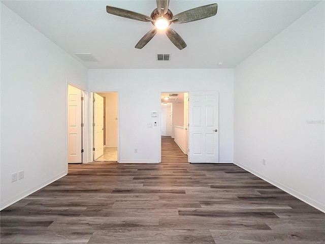 unfurnished bedroom with ceiling fan, dark hardwood / wood-style flooring, and ensuite bath