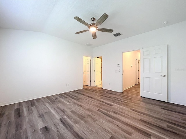 unfurnished bedroom featuring ceiling fan, lofted ceiling, dark hardwood / wood-style flooring, and ensuite bathroom