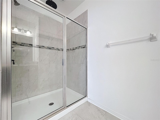 bathroom with a shower with door